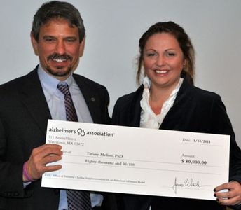 Alz. Assoc. Mellott check Dr. Mellott receives her check.