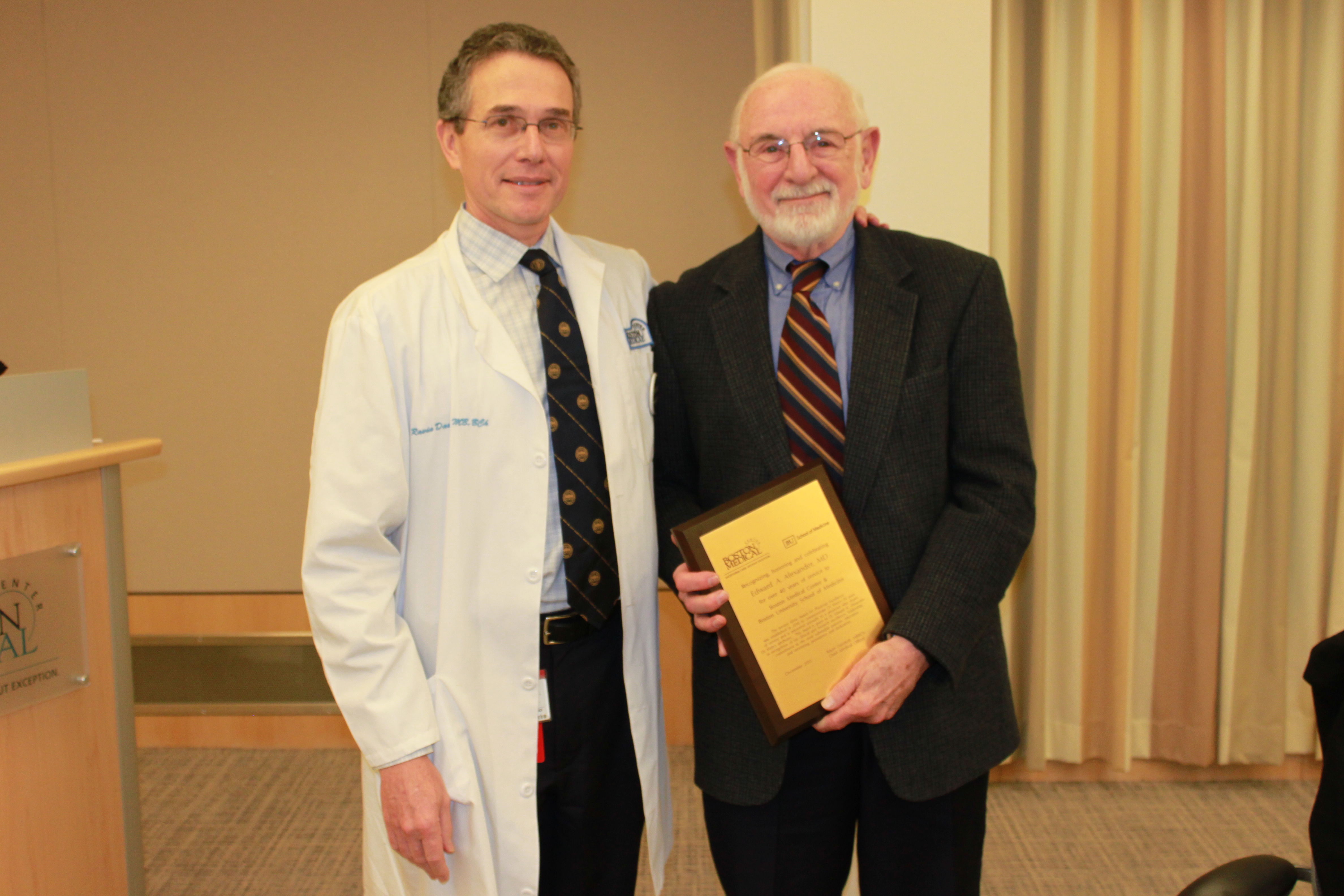 Edward Alexander, MD, (right) receives the Jerome Klein Award for Physician Excellence from Dr. Ravin Davidoff, Chief Medical Officer (left) at BMC.