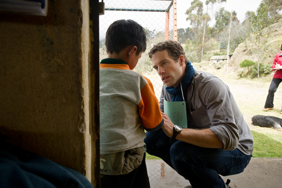 Owen Kendall (MED'14) inspects a student's infected cut during a health camp in rural Ecuador.