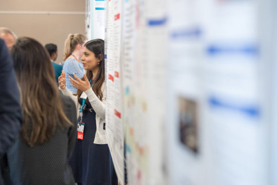 Researchers discussing work at the Health Equity Symposium poster session. Photo by Cydney Scott