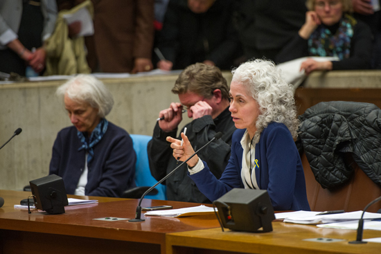CAPTION Barbara Ferrer (SPH’88), director of the Boston Public Health Commission (BPHC), testifies at last night’s NEIDL hearing at Boston City Hall; at left is M. Anita Barry, director of the BPHC Infectious Diseases Bureau, and Boston Police Department Lieutenant Paul O’Connor.