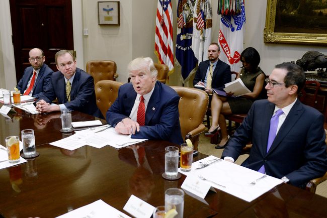 President Donald Trump, with Office of Management and Budget director Mick Mulvaney on his right and Treasury Secretary Steven Mnuchin on his left, discusses the federal budget at the White House February 22. Olivier Douliery/picture-alliance/dpa/AP Images