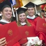 students smiling at graduation