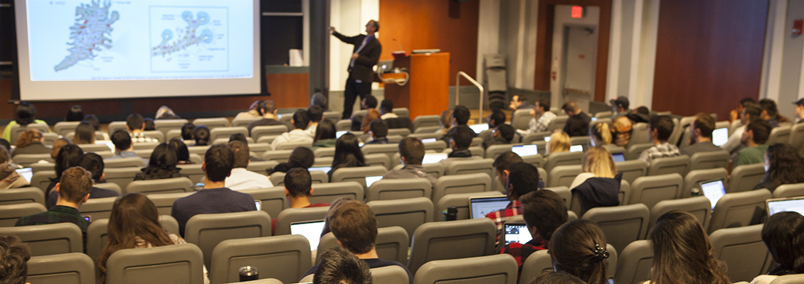 professor teaching in large lecture hall