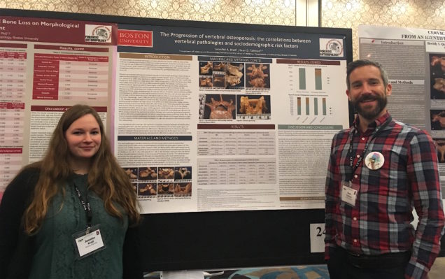 two students presenting a research poster