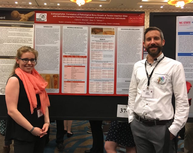 two students presenting a research poster