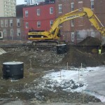 A bulldozer digging the foundation of the new Student Residence