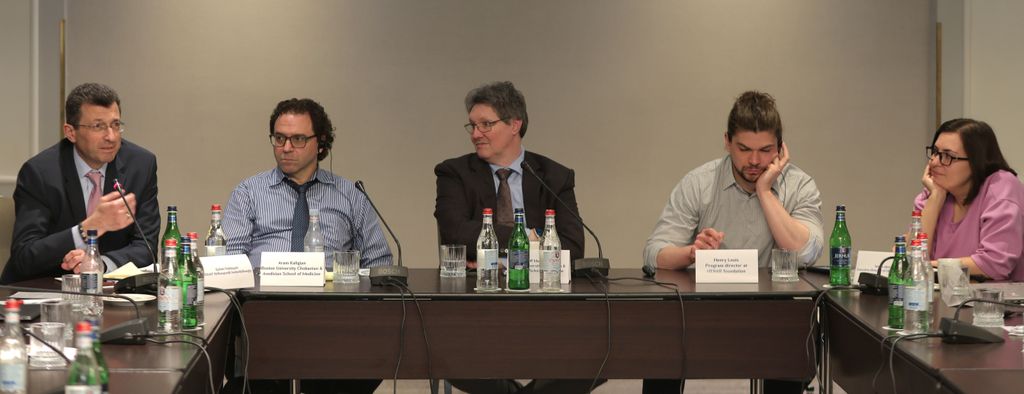 Four men, one woman sitting at large conference room table