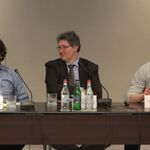 Four men, one woman sitting at large conference room table