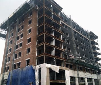 Note the contrast between the side with the brickwork and the unfinished portion. Brick work is well underway on this side of the structure.