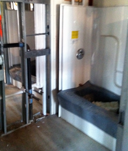 Bathroom under construction Tub-shower combination.
