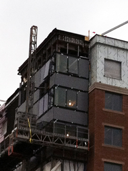 Glass being installed into curtain wall system. Glass being installed into curtain wall system.