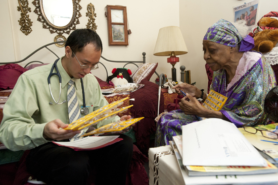 GERIATRIC Lee checks Harris’ medication cards for dates and dosage levels.