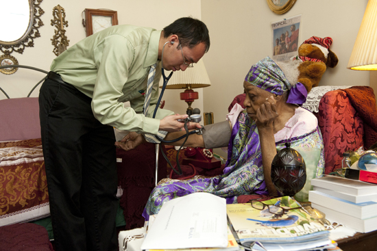 Lee takes Harris’ blood pressure as part of her home exam.