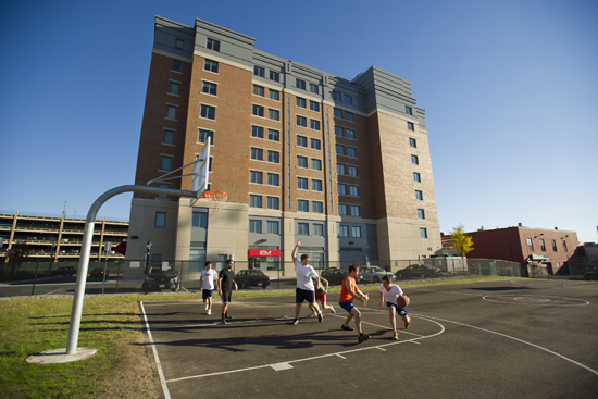 13-7105 FIELDOFDR-026 One of the amenities of the Field of Dreams behind the Medical Student Residence on Albany Street is the NBA-sized basketball court, where students can play a pickup game. Photo by Cyndey Scott