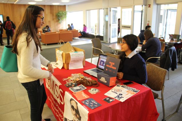 Tannu Singh, second year GMS student, talks to another student about Movember.