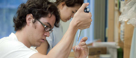 students in lab holding test tube