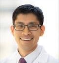 Image of Gene Kwan wearing a white coat