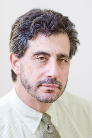 Head and shoulders shot of Howard Bauchner, dark facial and head hair, serious expression