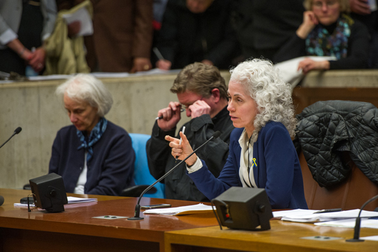 Barbara Ferrer (SPH’88), director of the Boston Public Health Commission (BPHC), testifies at last night’s NEIDL hearing at Boston City Hall; at left is M. Anita Barry, director of the BPHC Infectious Diseases Bureau, and Boston Police Department Lieutenant Paul O’Connor.