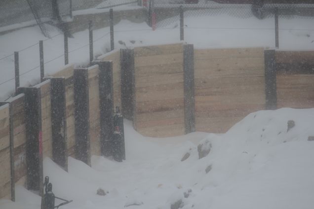 Piles driven into the snowy ground in preparation for the foundation. (Feb. 1, 2011)