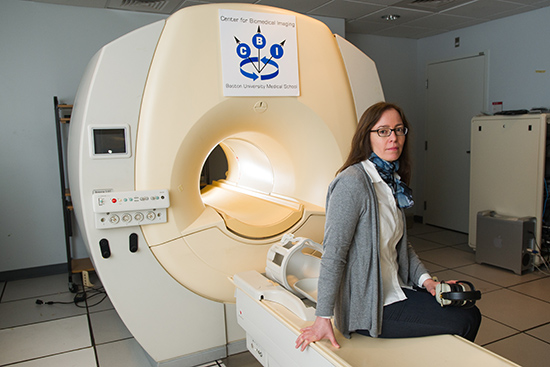 Researcher Karin Schon with a functional magnetic resonance imaging (fMRI) machine. Schon uses fMRI to study the connection between physical fitness and memory performance. Her work may eventually lead to interventions for Alzheimer’s disease. Photo by Cydney Scott