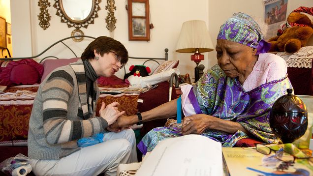 Medical professional taking care of an elderly person.