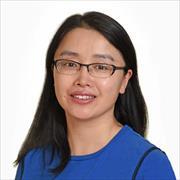 woman with long straight dark hair, eyeglasses, smiling, wearing blue dress