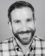 head and shoulders of Sean Tallman wearing plaid casual shirt, smiling broadly