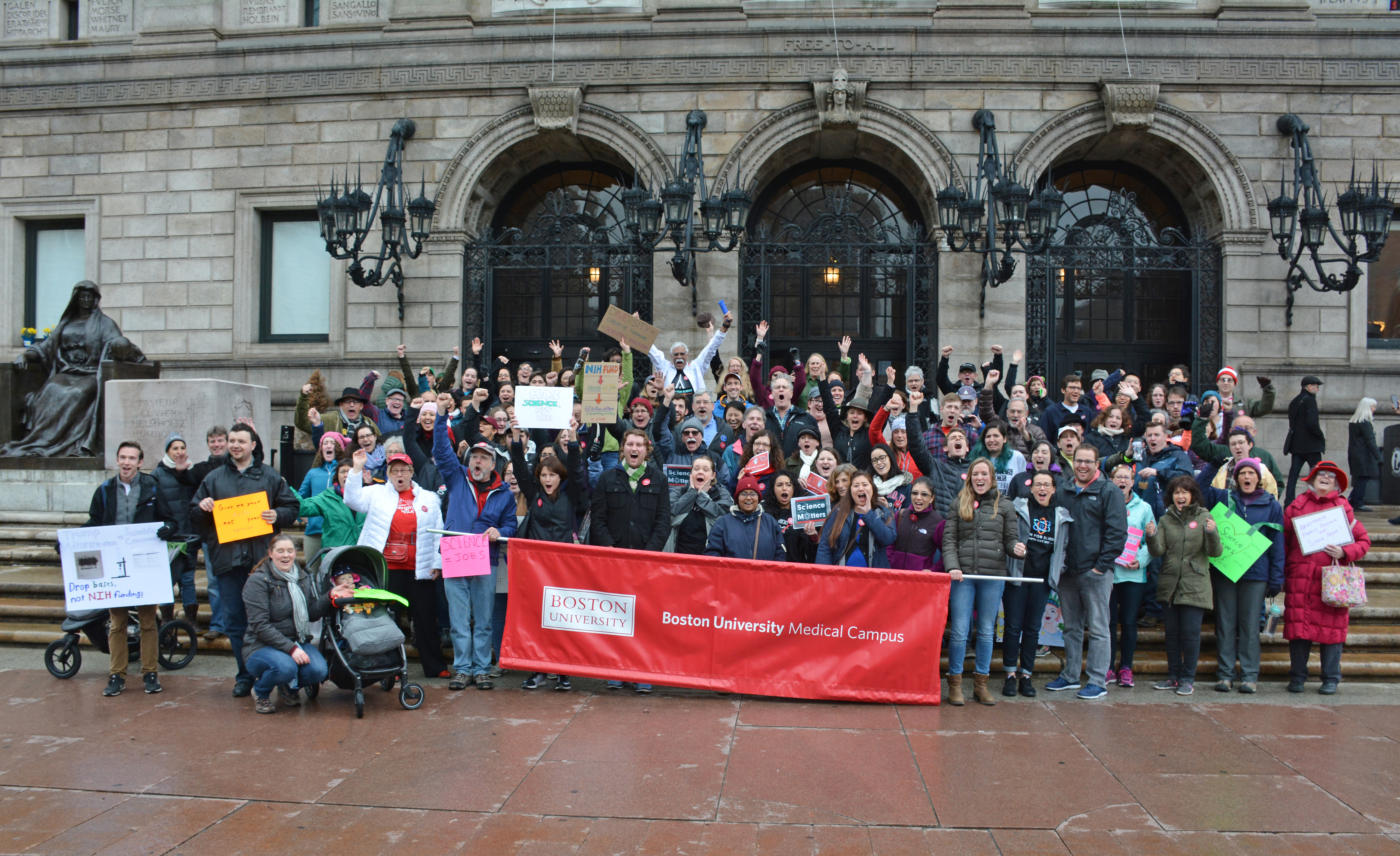 Faculty, staff and students gather at the steps of the Boston Public Library before marching to Boston Common.