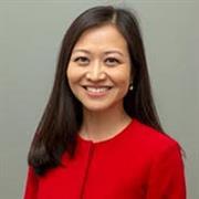 Woman in red top, long straight dark hair, smiling 