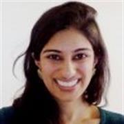 head and shoulders shot of Dr. Anand, long dark brown hair, smiling broadly