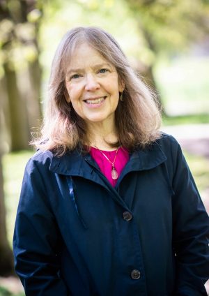 Image of Dr. Hillman wearing blue jacket and pink shirt