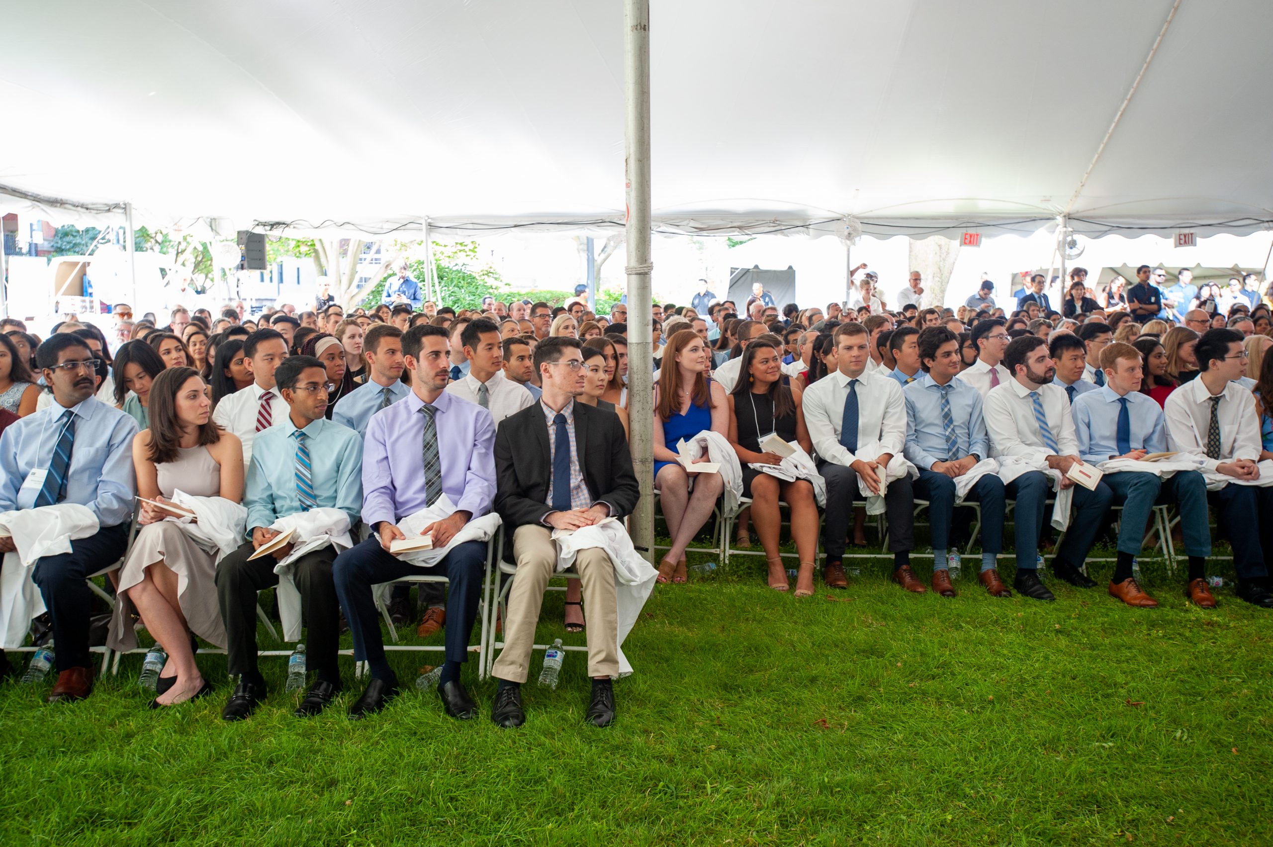 Students seated under a tent for the 2019 White Coat Ceremony.