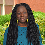 Headshot of Yvena Romulus in front of BUSM Instructional Building.