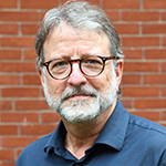 Headshot of James McKnight wearing a blue shirt.