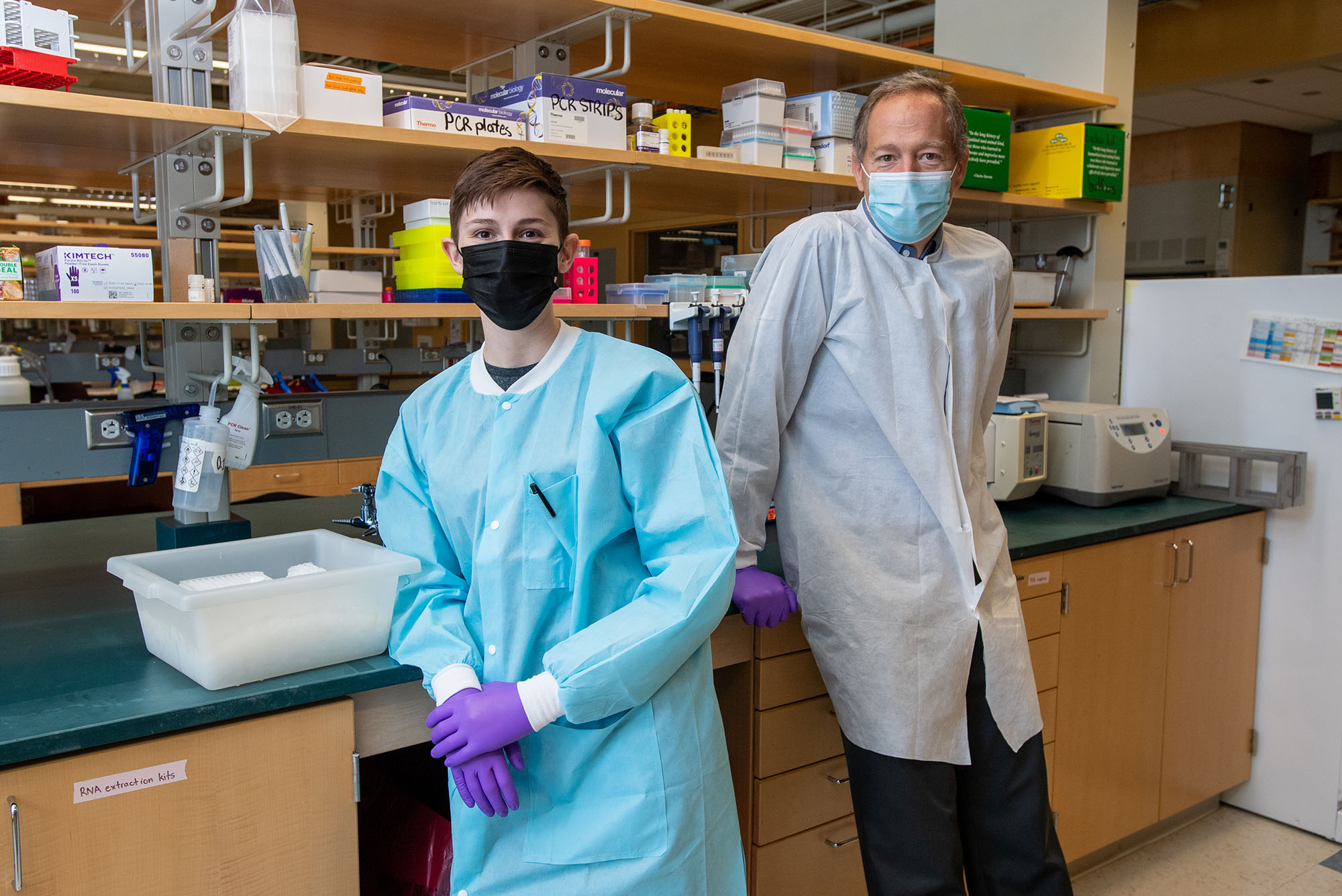 NEIDL scientists Jackie Turcinovic (left) and John Connor (right) in a science lab.