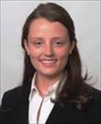 women with long dark straight hair wearing white blouse and dark suit jacket, smiling