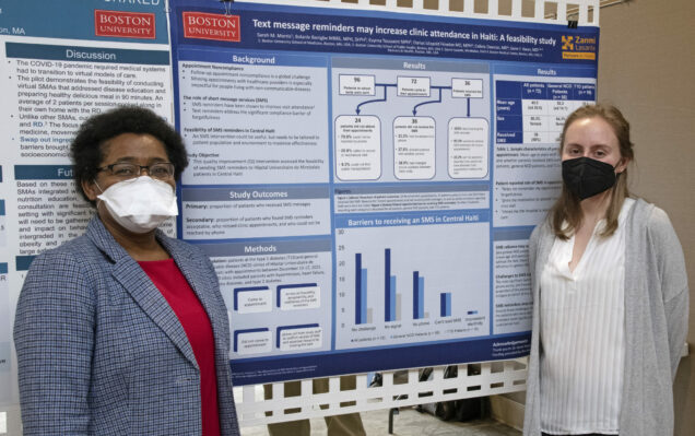 Dr. Joseph and Sarah Morris standing in front of a poster