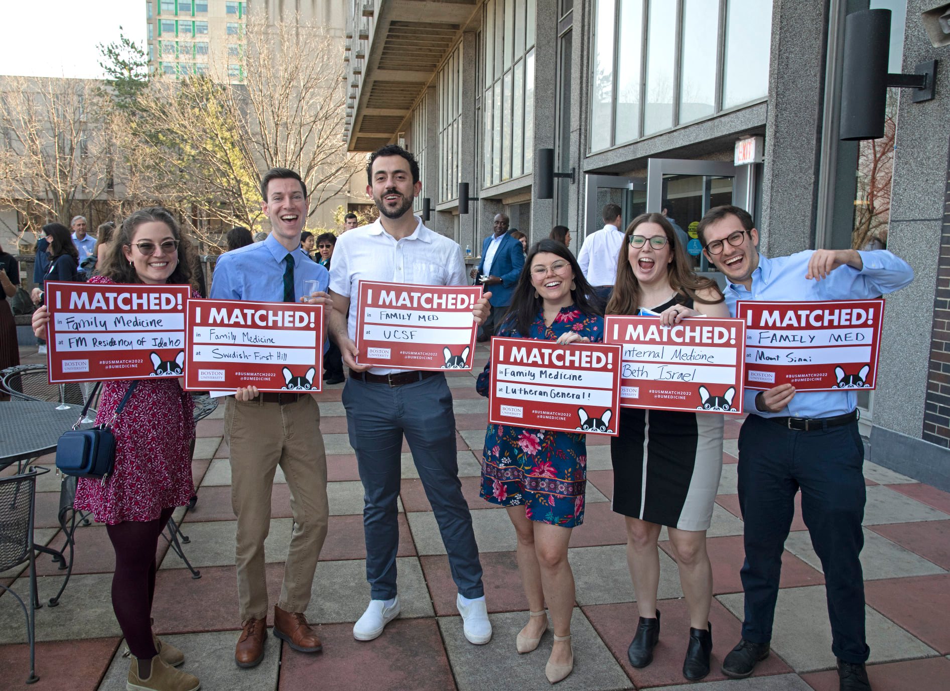 Six students holding signss indicating programs where they matched