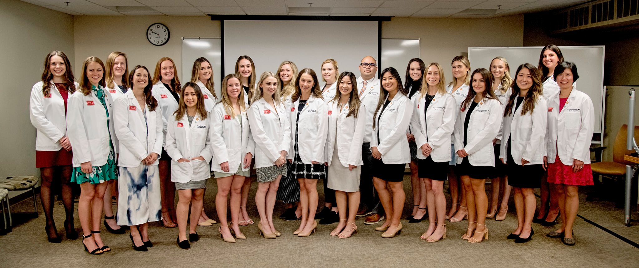 Whitecoat recipients all lined up together wearing their new whitecoats