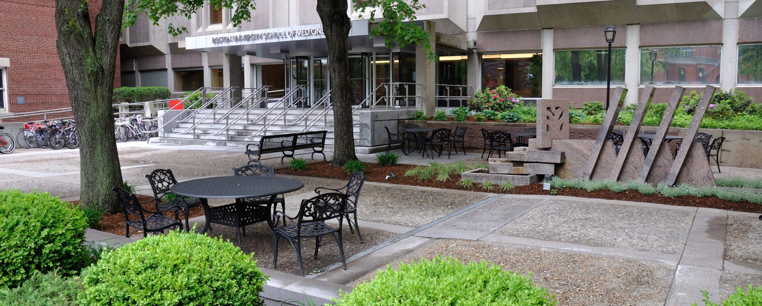 Empty tables and chairs in front of the Instructional buildingn 