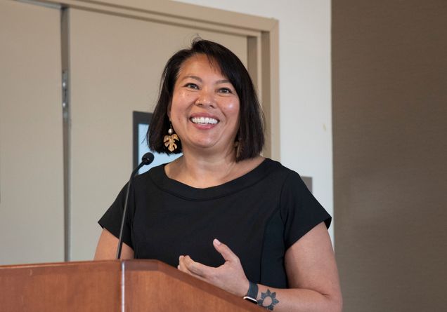 Liza Talusan speaking at a podium