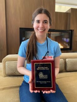 Lindsay Claus holding award plaque