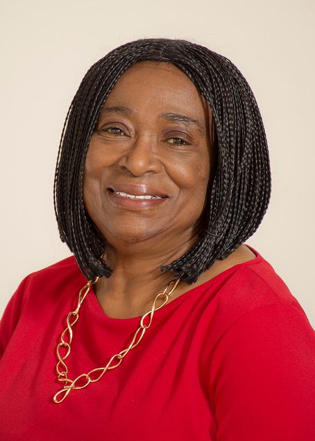 Black woman with shoulder length hair and red shirt