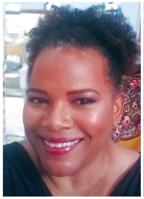 Headshot of a smiling black woman with her hair up