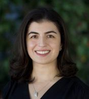 Headshot of Bita Naimi against a green background