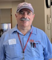 Headshot of Joe Ribeiro in blue shirt with BU logo