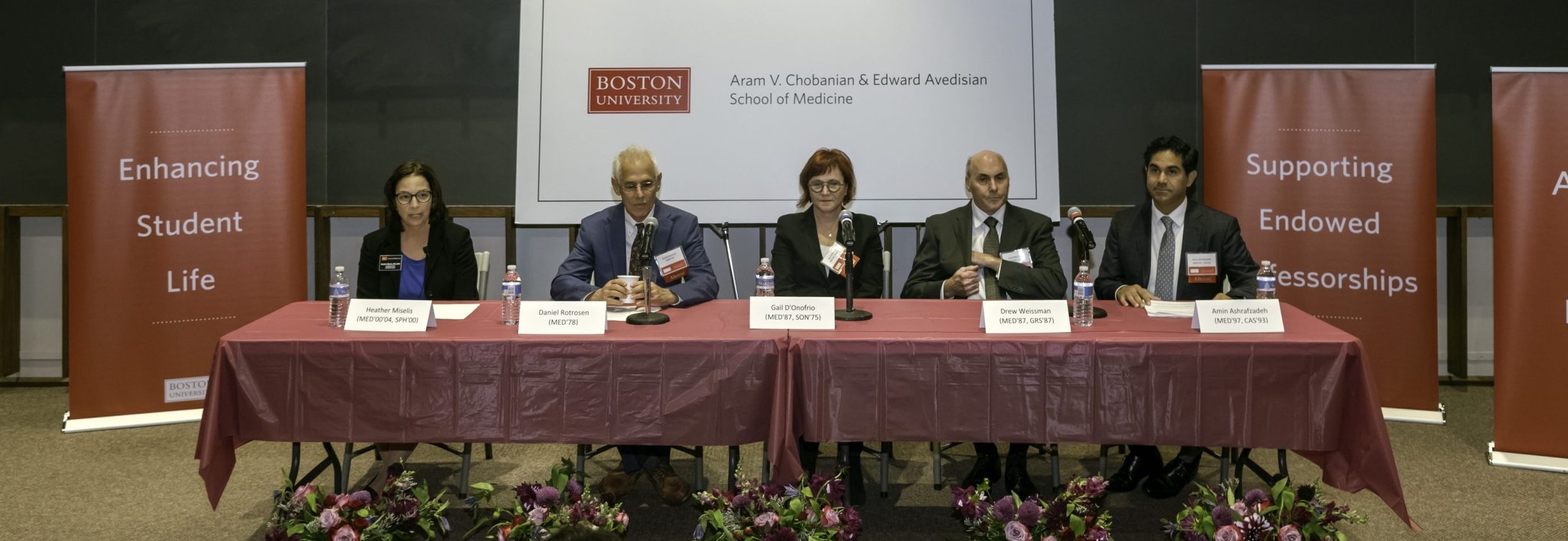 Three panelists and two comoderator seated at table