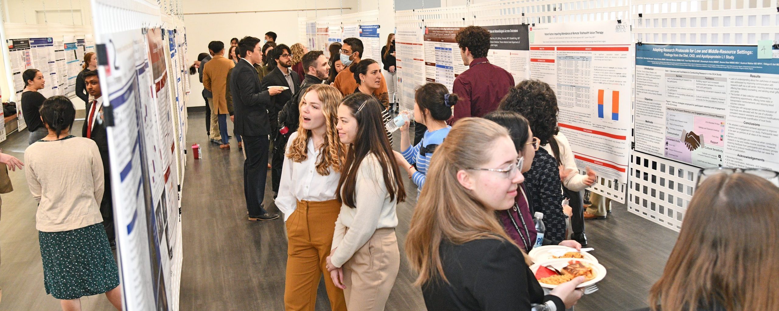 Medical students, faculty and guests viewing research posters